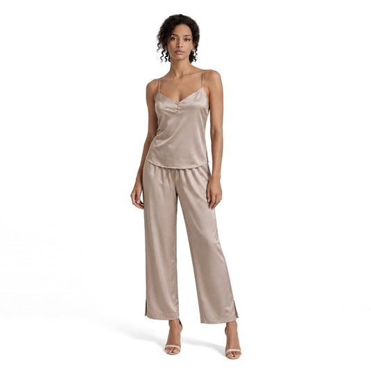 Woman wearing a champagne beige silky viscose two piece set with a V-neck cami top and flowing wide leg pants