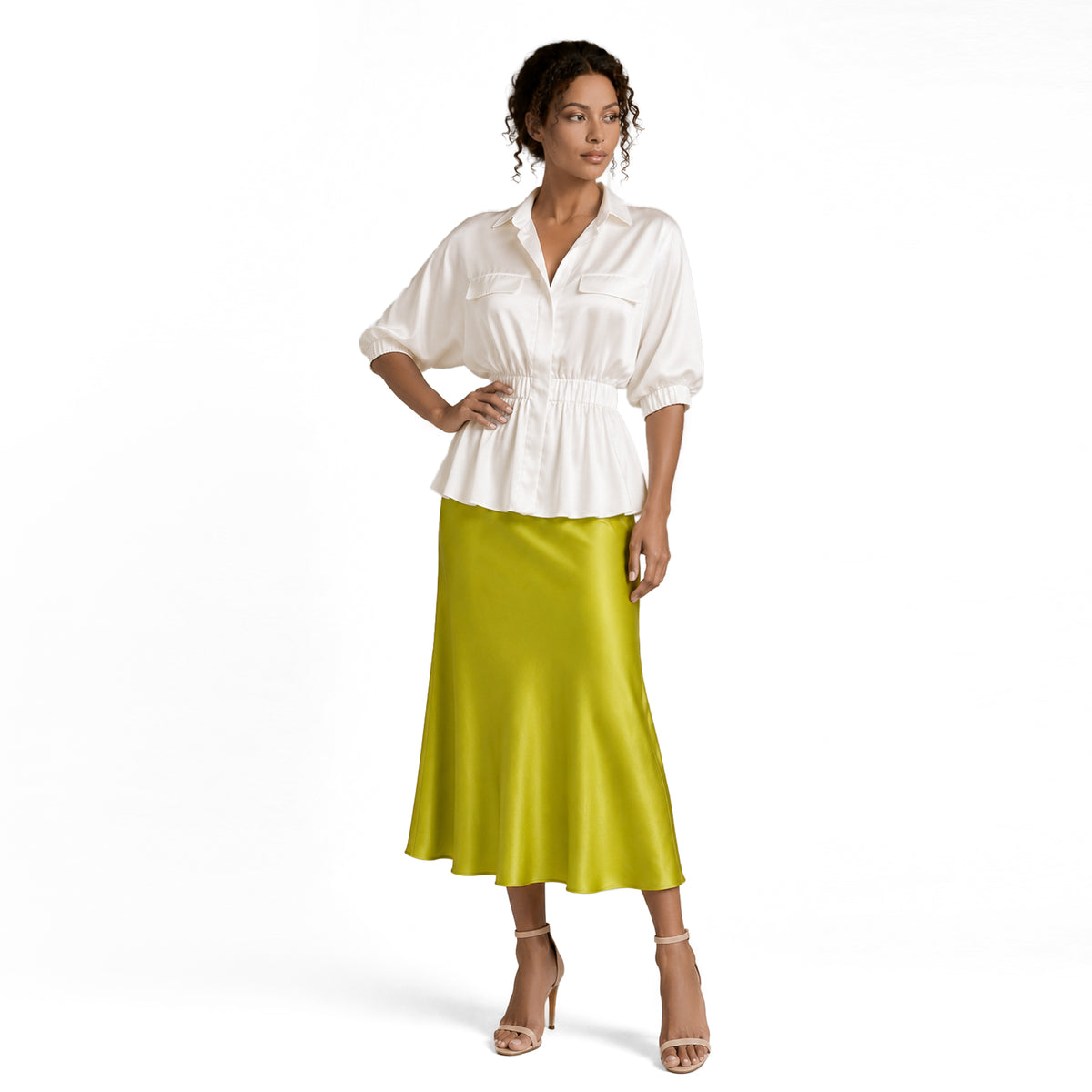 Full-length view of a white silky peplum blouse styled with a lime green satin midi skirt and nude heels